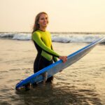 active women with surf board enjoy watersport at vacation holidays.