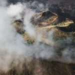 Aerial view of Batur volcano caldera in Bali. Volcanic black texture and crater rim