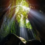 Rays of light at Tukad Cepung Waterfall in Bali, Indonesia